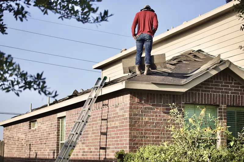 Professional roofer working on a residential roof in Babbatasset Village